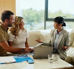 Couple meeting with financial advisor indoors