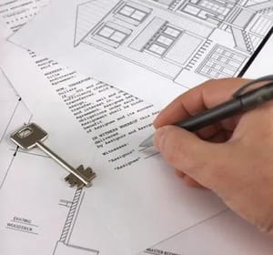 Architect reviewing building blueprints with key
